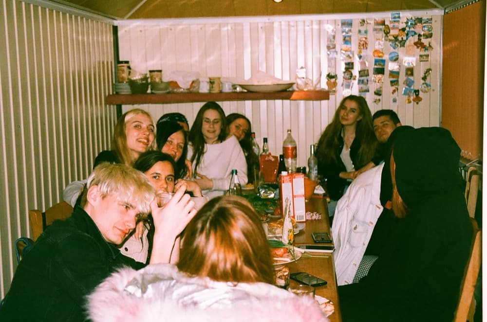 A crowd of friends squeezed into one flash-lit group shot